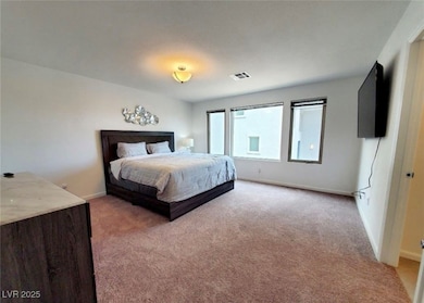 Bedroom featuring light colored carpet, baseboards