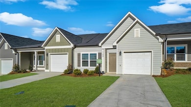View of front of property featuring a garage and a