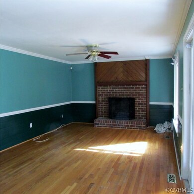 Family room with brick fireplace, hardwood floors,