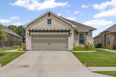 French country home with stone siding, an attache