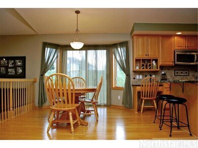 Informal dining room with hardwood floor and bayed