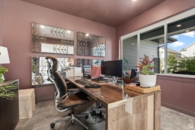 Home office featuring carpet and baseboards