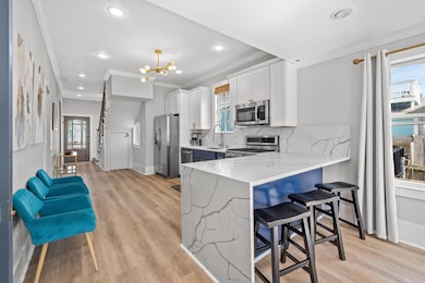 A breakfast bar with waterfall provides extra seat