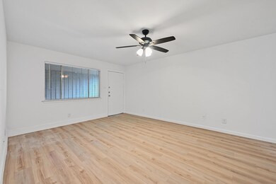 Empty room featuring ceiling fan, light wood fini