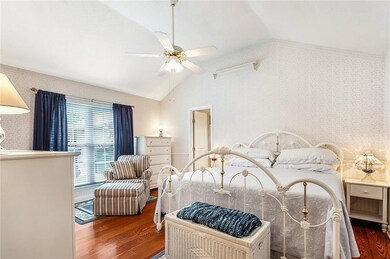 Oversized master bedroom with high ceiling and woo