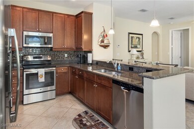Kitchen featuring light tile patterned floors, sin