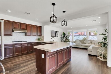 Kitchen featuring dark wood-style floors, under ca