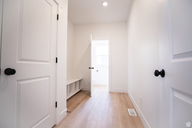 Excellent mudroom area off of garage with bench and cubbies, half bathroom and coat closet.