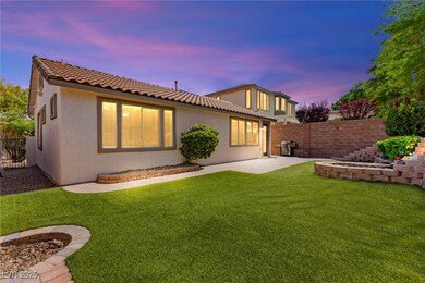 Back of property at dusk featuring stucco siding,