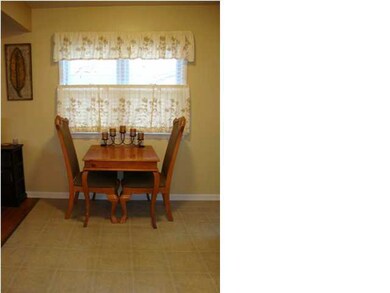 Eating space in kitchen with custom wood blinds on