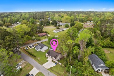 Birds eye view of property featuring a view of tre