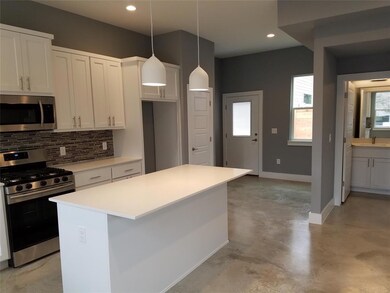 Kitchen featuring baseboards, a kitchen island, a