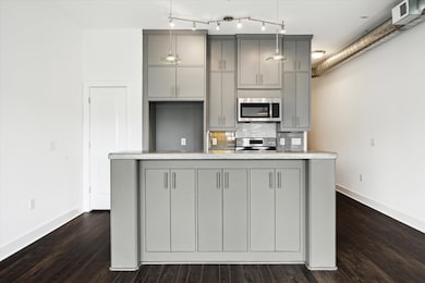 The kitchen features a eat in island with sink. Yo