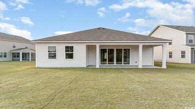 Rear view of property with a yard and a patio area