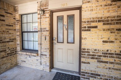 Doorway to property with brick siding