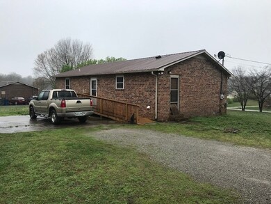 This home sits on a large corner lot driveway is on baker st. This picture reflects back / side view large concrete pad for patio, parking, etc