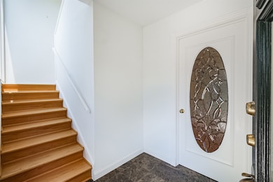 A private entry with marble floors welcomes guests