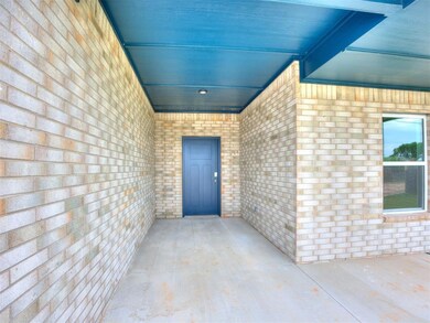 View of exterior entry with brick siding