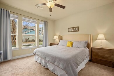 Carpeted bedroom with baseboards and a ceiling fan