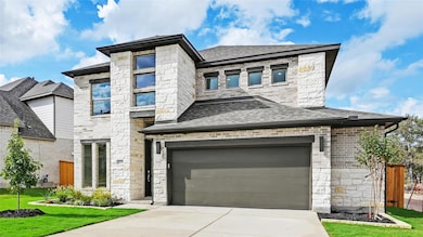 View of front facade featuring stone siding, concrete driveway, a garage, and a front lawn