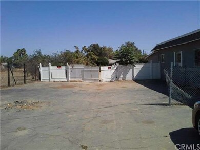 PARKING AREA AND ENTRANCE TO BACK YARD. PLENTY OF 