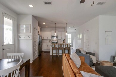 Open concept living leads into the living room and dining space. Step out the side door onto another covered patio!