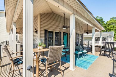 View of patio with outdoor dining area and ceiling fan