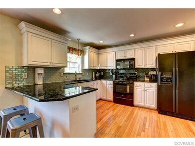Sexy kitchen with classic white cabinetry, granite