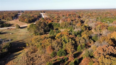 Aerial view of property and surrounding area featuring a heavily wooded area