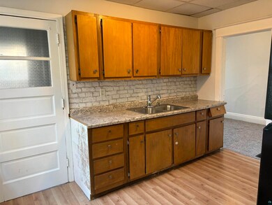 Kitchen featuring backsplash, a paneled ceiling, l