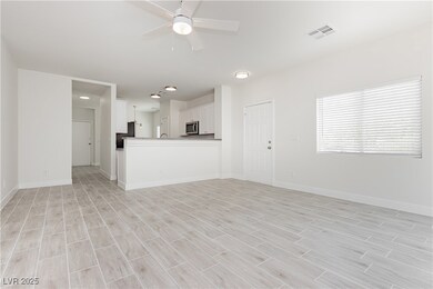 Unfurnished living room with a ceiling fan and lig