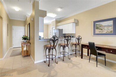 Kitchen featuring white cabinetry, a breakfast bar