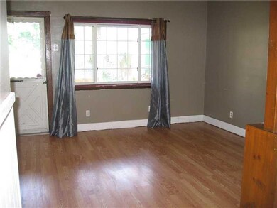 Living Room. Sunlit with laminate floors and neutr