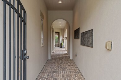 Private gated entry opens to a charming brick-line