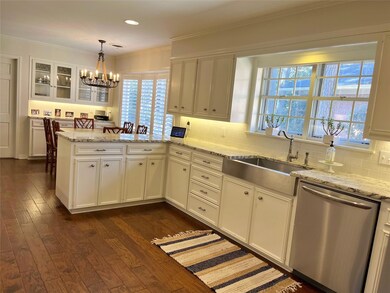 Kitchen with white cabinets, dishwasher, a peninsu