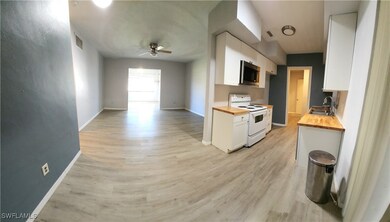 Kitchen with wood counters, white electric range,
