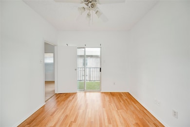 Unfurnished room featuring baseboards, ceiling fa
