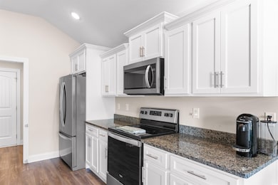 Kitchen featuring lofted ceiling, stainless steel 