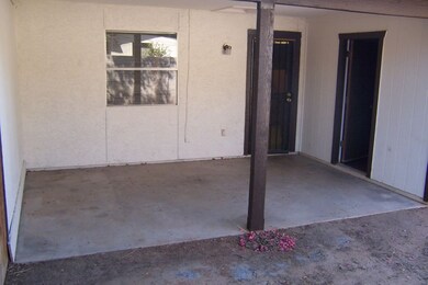 Covered patio with laundry/storage room.