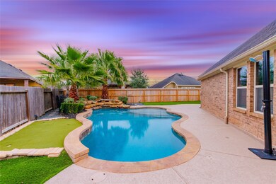 This backyard oasis features a stunning pool with