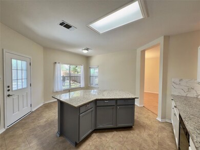Kitchen featuring gray cabinets, light tile patte