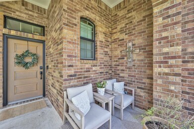 This is a cozy, welcoming front porch with a wood-