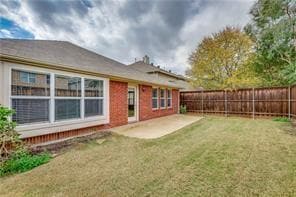 Back of property with a patio and a yard