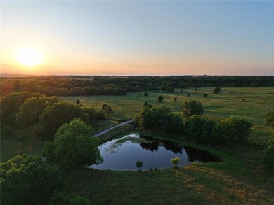 Aerial view at dusk of a water view and a rural view