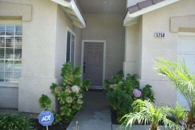Shaded private entry surrounded by plush greenery