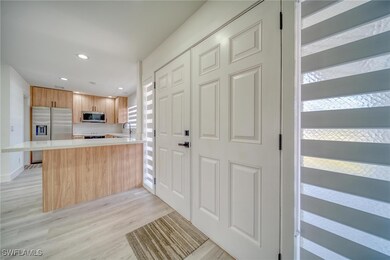 Kitchen featuring light wood-style flooring, a sin