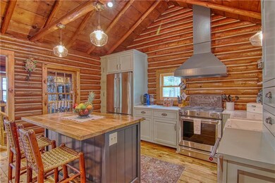 Upon entering the Main Cabin, one is in awe of the amazing professional Kitchen! Don't you just love the beautiful logs and wood everywhere?!