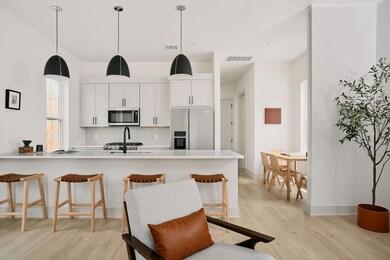 Kitchen featuring backsplash, light wood-style fl