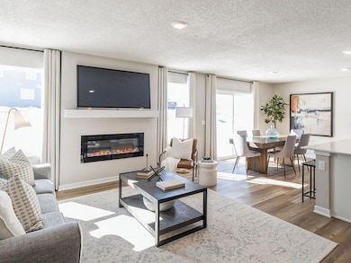 Open concept Harmony living room and dining area.  Model home shown. Colors will vary.