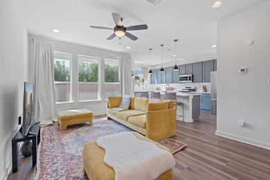 Living room with dark wood-style floors, ceiling 